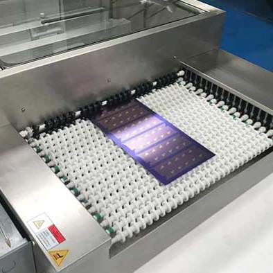 A sheet of metal is extracted from a chemical milling machine