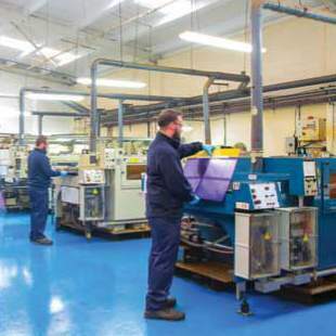 Workers producing etched titanium parts